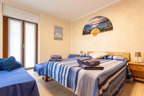 a bedroom with two beds and a window at Veruskacamere Camera 1 in Somma Lombardo