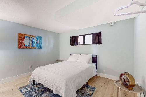 a white bedroom with a bed and a window at Capri 104 in Marco Island