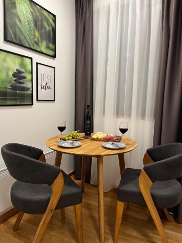 a dining room with a table with two glasses of wine at Jahorina Apartment4Two in Jahorina