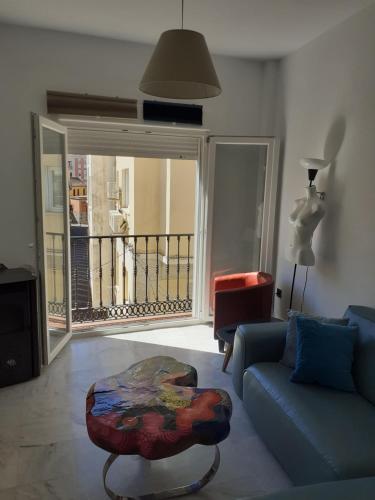a living room with a couch and a table at Pop Art House Center 2 Bedrooms in Málaga