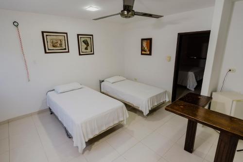 Postel nebo postele na pokoji v ubytování Hotel Rancho Regis
