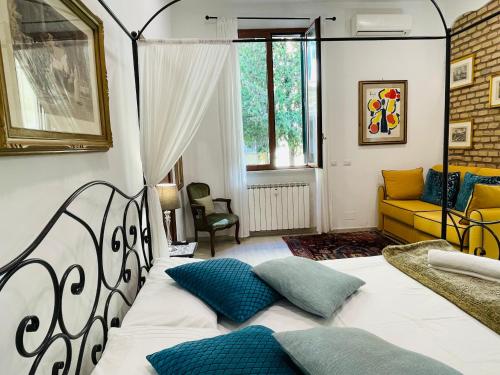 a bedroom with a large white bed with blue pillows at Colosseum-Apartments in Rome