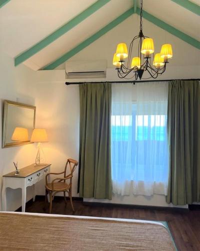 a room with a desk and a chair and a window at Hotel Boutique La Perouse in Hanga Roa
