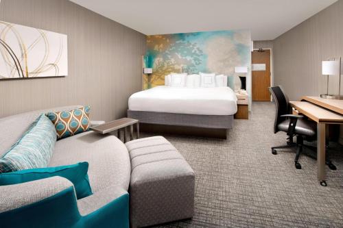 a hotel room with a bed and a desk at Courtyard by Marriott Portland Hillsboro in Hillsboro