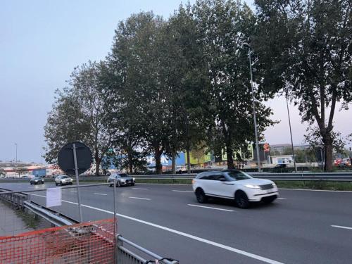 a white car driving down a highway at Appartamento a Milano, 12 minuti dalla stazione centrale FS in Cinisello Balsamo