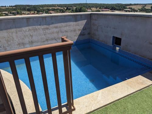a swimming pool on the roof of a house at Casa Rural El Mayadero in Zamora