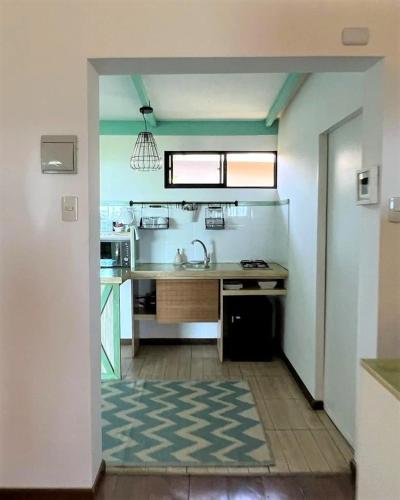 a kitchen with a sink and a counter top at Hotel Boutique La Perouse in Hanga Roa