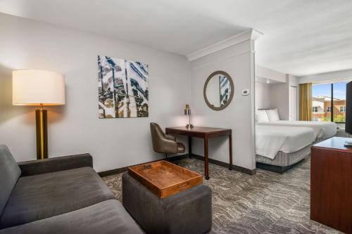 a hotel room with a bed and a couch at SpringHill Suites Phoenix Glendale Sports & Entertainment District in Glendale