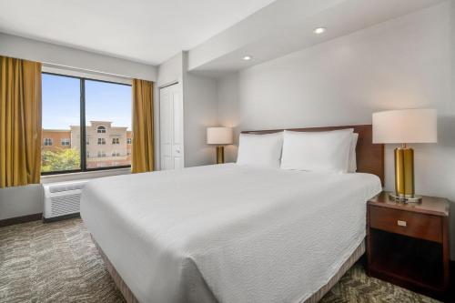 a bedroom with a large white bed and a window at SpringHill Suites Phoenix Glendale Sports & Entertainment District in Glendale