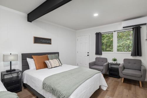 a bedroom with a large bed and a chair at The Lofts on Indian Point - Near Silver Dollar City in Branson