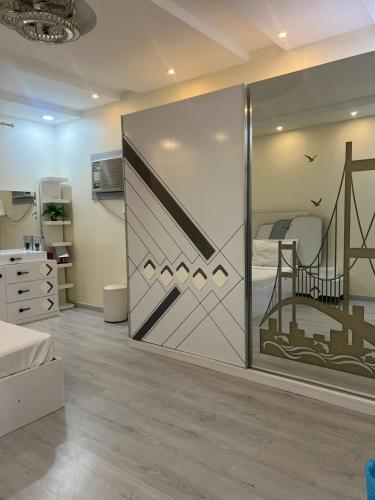 a room with a sliding glass door with a bedroom at Holiday apartment in Makkah