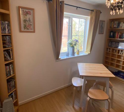 a dining room with a table and a window at Cardiff Bay Apartment in Cardiff