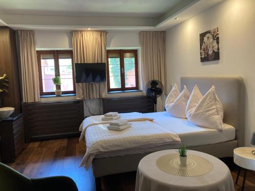 a hotel room with a bed and two tables at Penzion Moravia - free parking in the city center in Mikulov