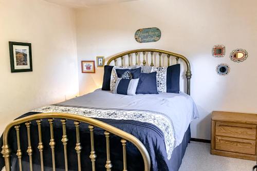 a bedroom with a bed with blue and white pillows at The Buck House in South Fork