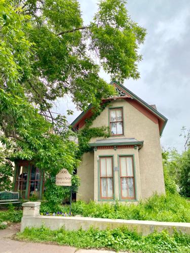 a small house with a sign on the side of it at Pansy’s Parlor Bed & Breakfast in Golden