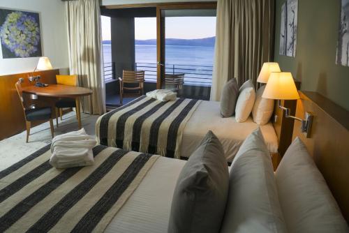 a hotel room with two beds and a view of the ocean at Park Lake Luxury Hotel in Pucón