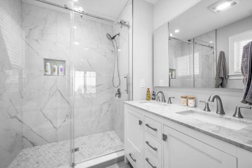 a white bathroom with a shower and a sink at 114 Salt Marsh Road East Sandwich Seaglass in East Sandwich