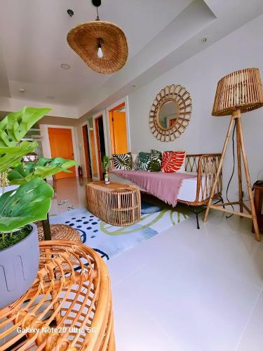 a living room with a couch and a mirror at Holiday Escape Philippines in Manila