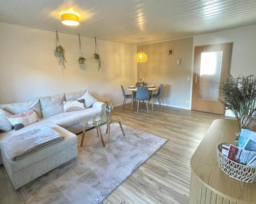 ein Wohnzimmer mit einem Sofa und einem Tisch in der Unterkunft Ferienwohnung Tiefenbach mit Garten in Oberstdorf