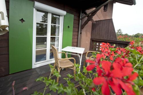 a patio with a table and chairs on a house at Hotel Wittelsbacher Hof in Utting am Ammersee