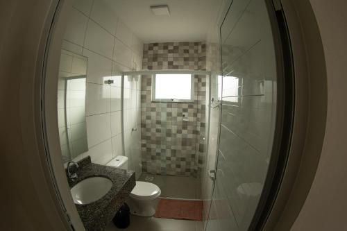 uma casa de banho com um chuveiro, um lavatório e um WC. em 1- MAHALO - Aloha Bratz Apartments em Palhoça