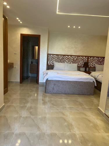 a bedroom with a large bed and a tile floor at Pyramids Height Hotel & Pyramids Master Scene Rooftop in Cairo