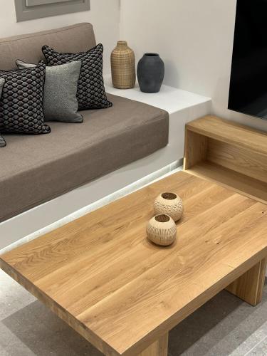 a living room with a couch and a wooden coffee table at Anatelo house in Fira