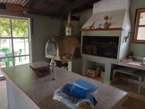 cocina con encimera y chimenea en La Chona en Vaqueros