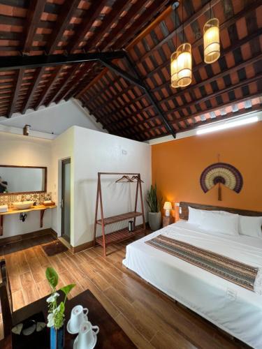 a bedroom with a large bed and a wooden ceiling at Thom's House in Ninh Binh