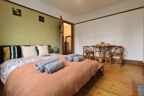 a bedroom with a bed with towels on it at House on Costal Village free parking in Peacehaven