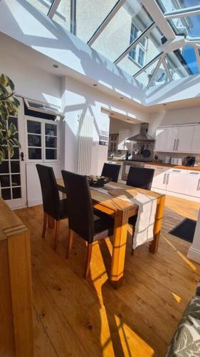 a dining room with a table and chairs in a kitchen at House on Costal Village free parking in Peacehaven