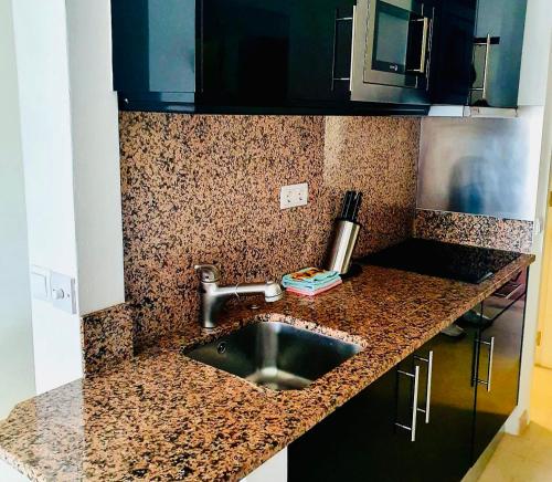 a kitchen with a sink and a counter top at Lagos Marina view apartment near beaches and shops in Lagos