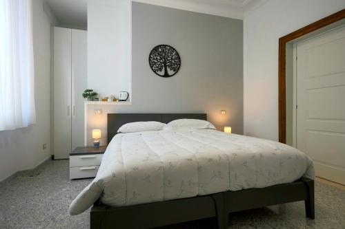 a bedroom with a bed and a clock on the wall at Al Castello Avezzano in Avezzano