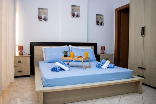 a bedroom with a bed with a table on it at Amazing Paradise Sensation 2 Bedroom Luxury Apartment with a Jacuzzi in Durrës