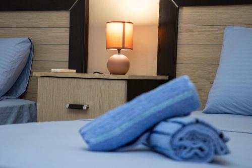 a blue blanket on a bed in a hotel room at Amazing Paradise Sensation 2 Bedroom Luxury Apartment with a Jacuzzi in Durrës