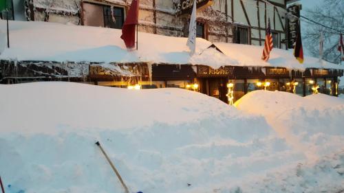 two piles of snow in front of a building at Le Cedrus Hotel in Al Arz