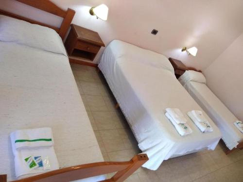 Hotel Rucalen في سانتا روزا: سريرين في غرفة صغيرة بها