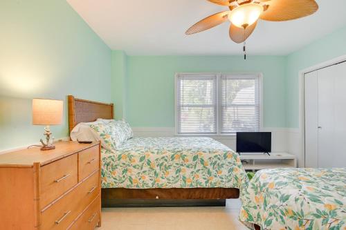 a bedroom with two beds and a ceiling fan at Pawleys Island Retreat - Golf Cart Included! in Pawleys Island
