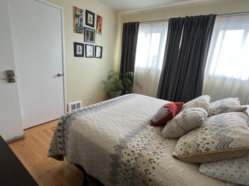 a bedroom with a bed with pillows on it at 2 Bedroom House OR Private Studio near SF, SFSU and SFO in Daly City