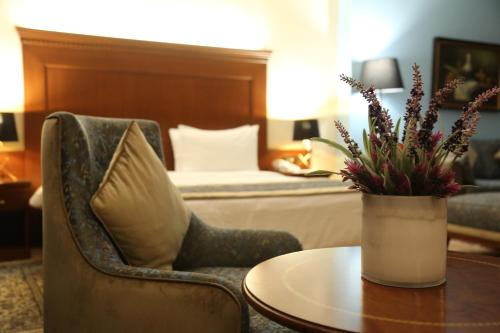 a room with a table and a chair and a couch at Le Cedrus Hotel in Al Arz