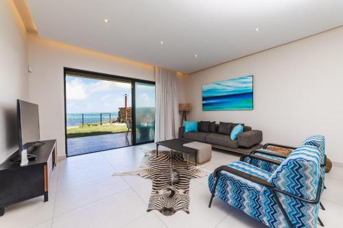 a living room with a couch and a zebra rug at Ocean Terraces Apt A1 - Your Beachfront Bliss - Brand NEW in Poste Lafayette