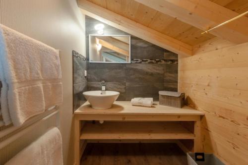 a bathroom with a sink and a mirror at Chalet La Voraz in Châtel