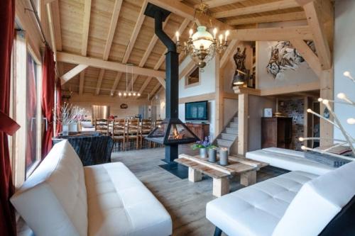 a living room with a couch and a fireplace at Chalet La Voraz in Châtel