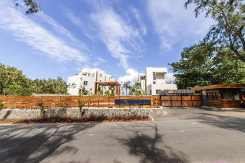 a building with a fence in front of it at Ocean Terraces Apt A1 - Your Beachfront Bliss - Brand NEW in Poste Lafayette