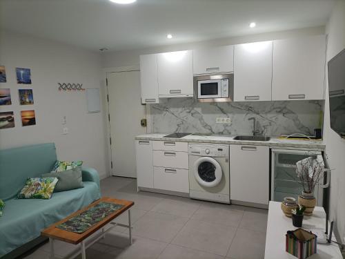 a kitchen and living room with a washing machine at Marea apartamento. in Adra