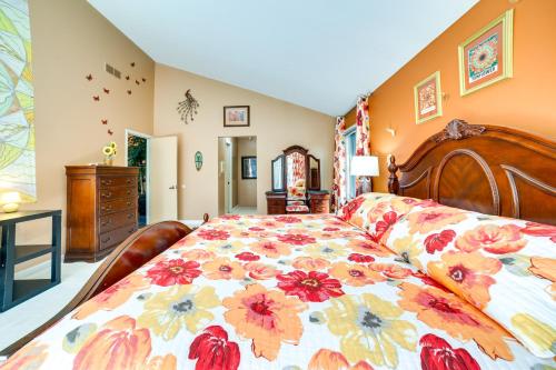 a bedroom with a large bed with a floral bedspread at Pet-Friendly Pennsylvania Abode - Deck and Fireplace in Gibsonia