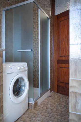 a washing machine in a bathroom next to a door at Casa CarLina in Treviglio