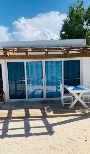 a deck with a table and a chair on a house at La Isla Bonita in Punta Rucia