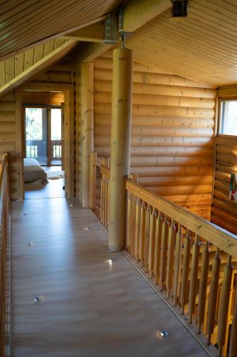 a hallway in a log cabin with a wooden wall at The Flysch in Miríki