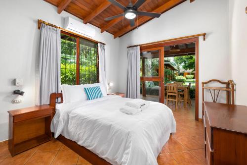 a bedroom with a bed and a desk and a window at Hotel Bahia Esmeralda in Potrero